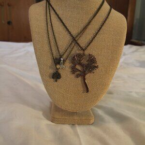 Necklace two for one. Trees, butterfly, and crystal. Good condition.